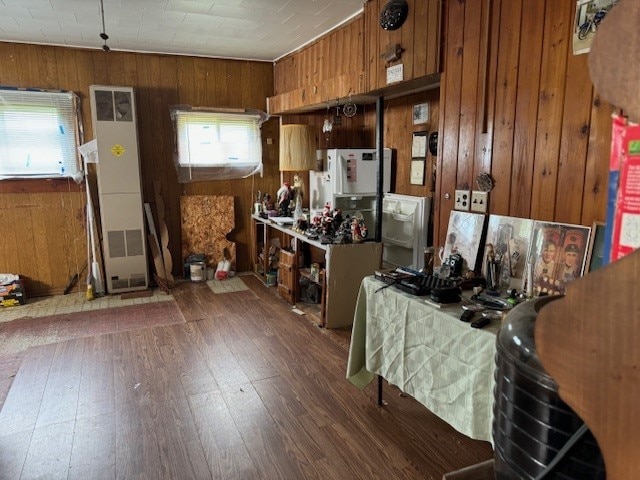 kitchen with wood walls and dark wood-type flooring