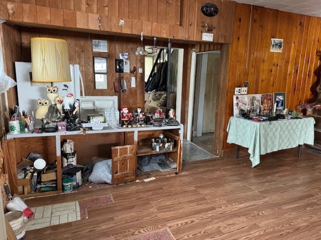 miscellaneous room featuring wood walls and hardwood / wood-style flooring