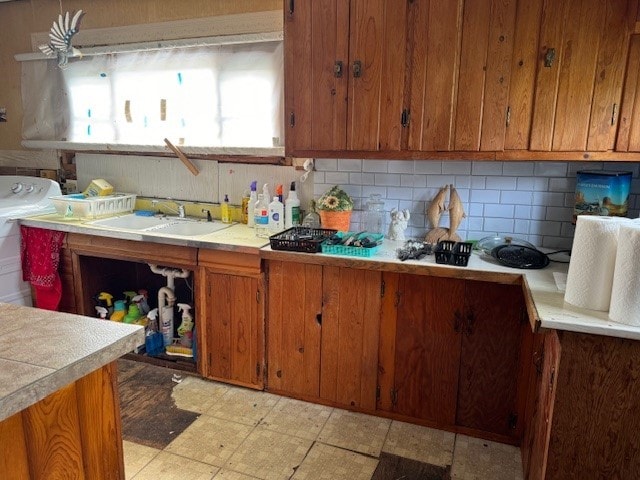 kitchen featuring decorative backsplash and sink