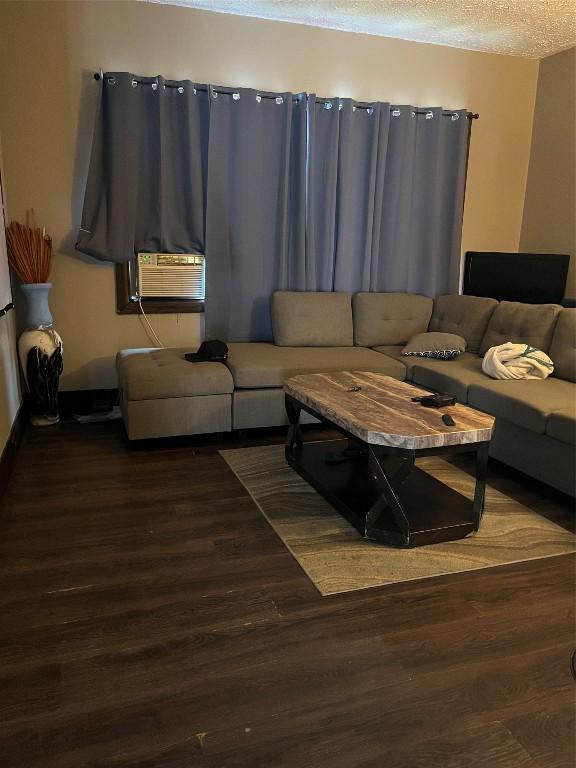 333 E 27th St, Erie, PA 16504 - living area with wood finished floors, cooling unit, and a textured ceiling