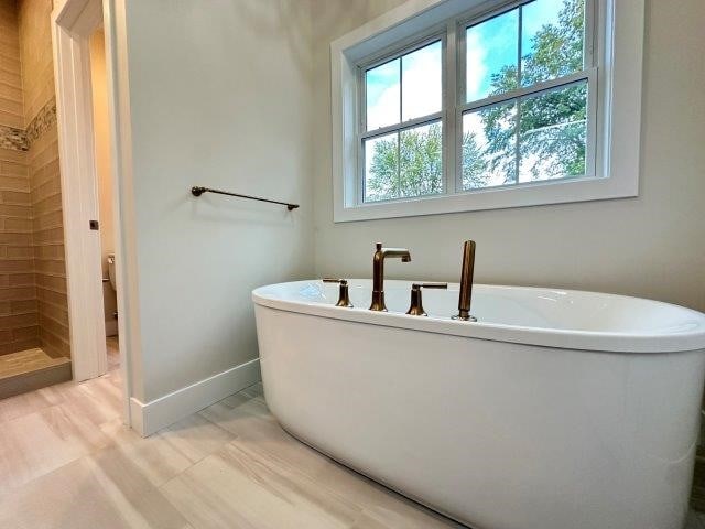 4655 Elsie Rd Unit 1, Erie, PA 16511 - full bathroom with a freestanding bath and baseboards