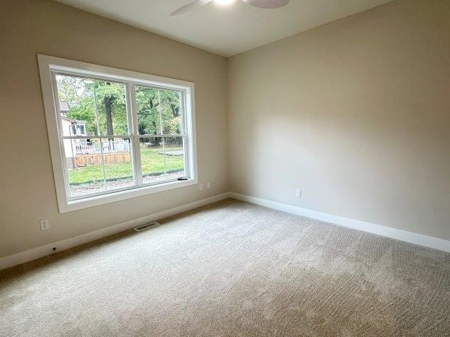 carpeted empty room with ceiling fan