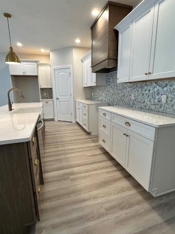 4655 Elsie Rd Unit 1, Erie, PA 16511 - kitchen with light wood-style flooring, tasteful backsplash, hanging light fixtures, recessed lighting, and light countertops