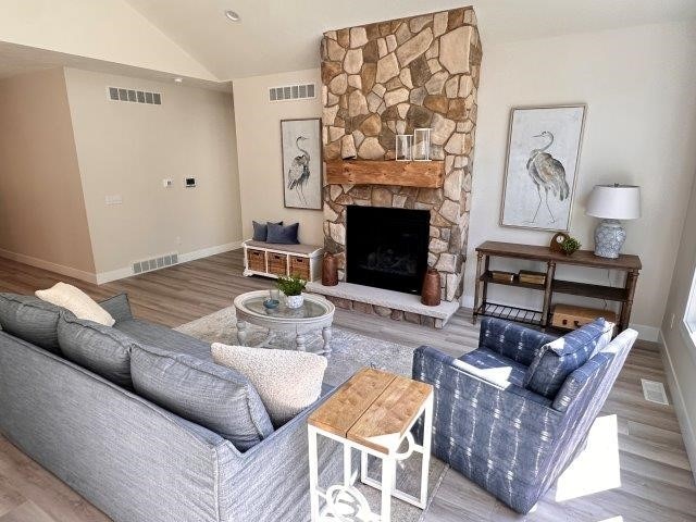 4655 Elsie Rd Unit 1, Erie, PA 16511 - living room with wood finished floors, lofted ceiling, and a stone fireplace