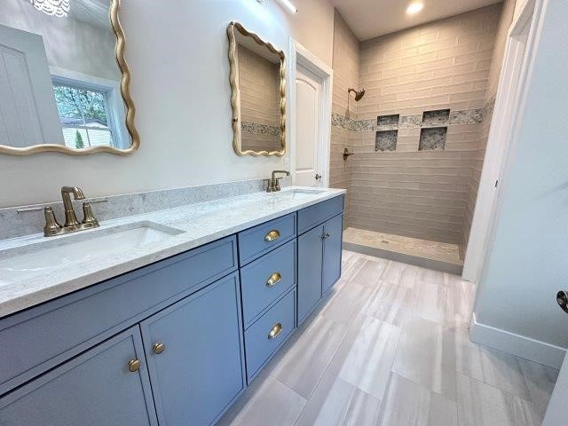 bathroom featuring vanity and a tile shower