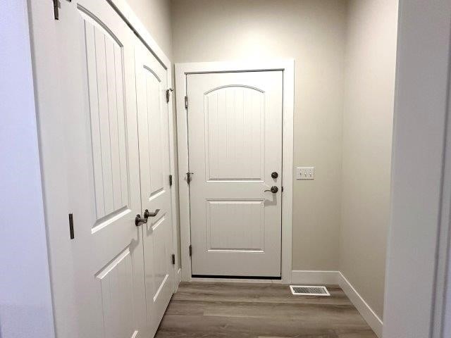 doorway with wood-type flooring