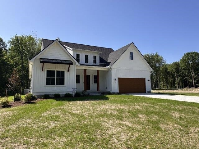 4655 Elsie Rd Unit 1, Erie, PA 16511 - modern farmhouse style home with concrete driveway, board and batten siding, a front lawn, and a porch