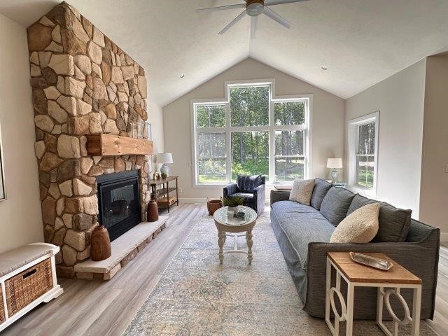 4655 Elsie Rd Unit 1, Erie, PA 16511 - living room with wood finished floors, a ceiling fan, a fireplace, and lofted ceiling