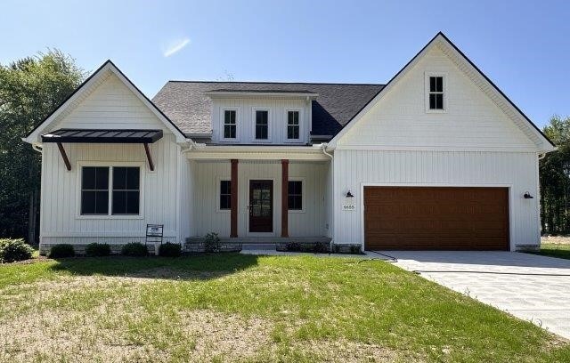 4655 Elsie Rd Unit 1, Erie, PA 16511 - modern farmhouse style home featuring a front lawn, concrete driveway, a porch, and a garage