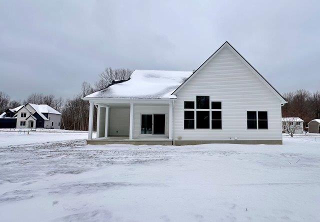 view of snow covered rear of property