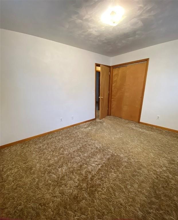 unfurnished bedroom featuring a closet and carpet floors