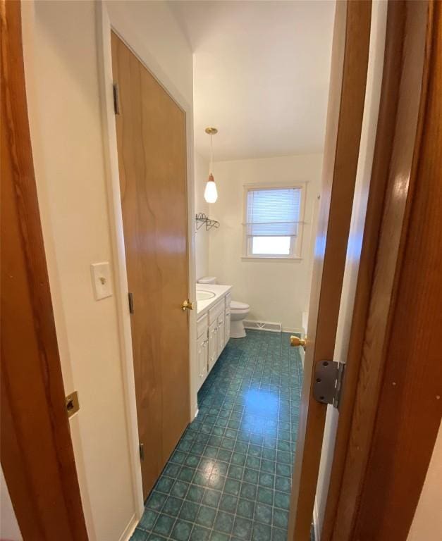 bathroom featuring vanity and toilet