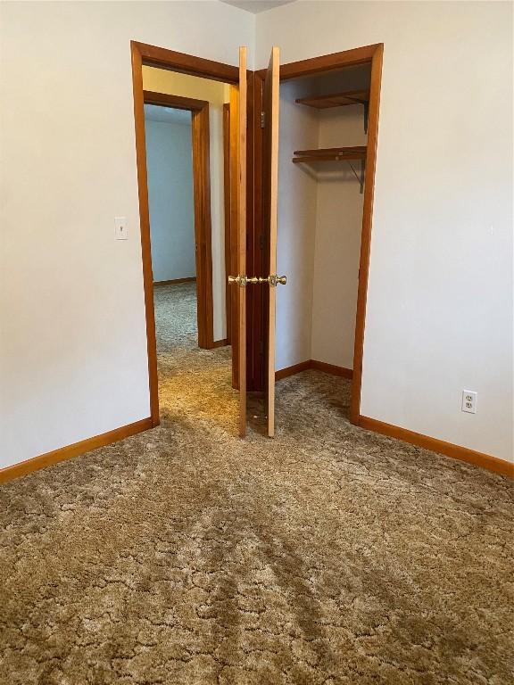 unfurnished bedroom featuring a closet and carpet