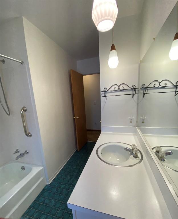 bathroom featuring shower / bathing tub combination and vanity