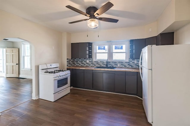 kitchen with white appliances, dark wood-type flooring, a sink, open shelves, and tasteful backsplash