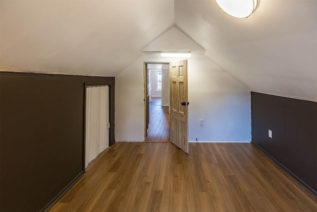 bonus room with vaulted ceiling and wood finished floors