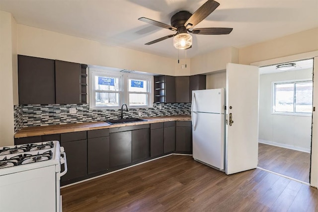 kitchen with white appliances, wooden counters, open shelves, and a sink