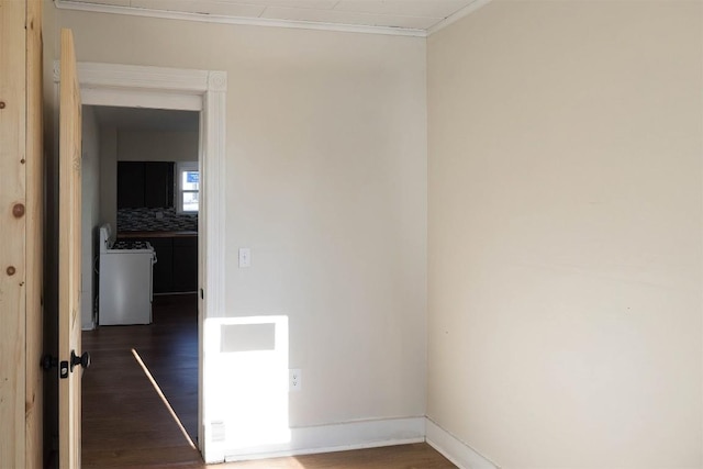 empty room with baseboards, ornamental molding, and wood finished floors