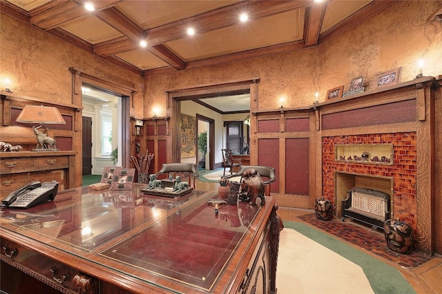 office space featuring beam ceiling, a fireplace, coffered ceiling, and ornamental molding