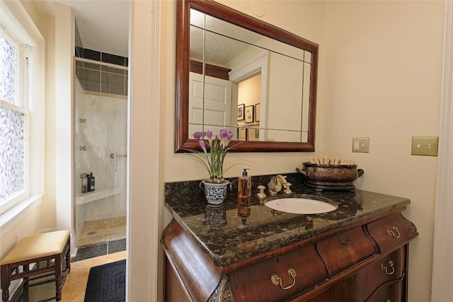 bathroom with tile patterned flooring, vanity, and a shower with door