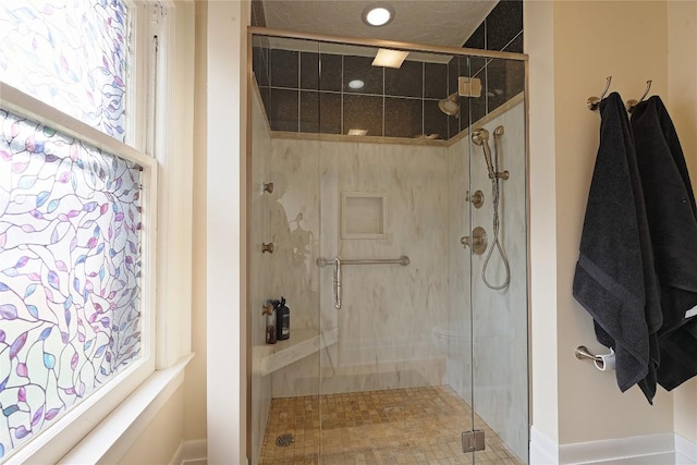 bathroom featuring plenty of natural light and walk in shower