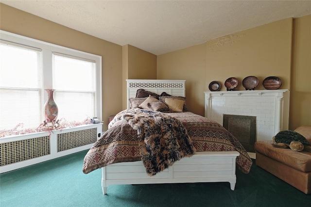 carpeted bedroom with a fireplace and radiator