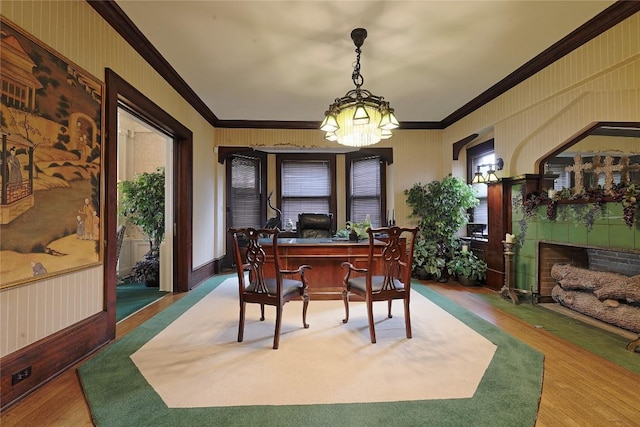 office space with a chandelier, wood-type flooring, and ornamental molding