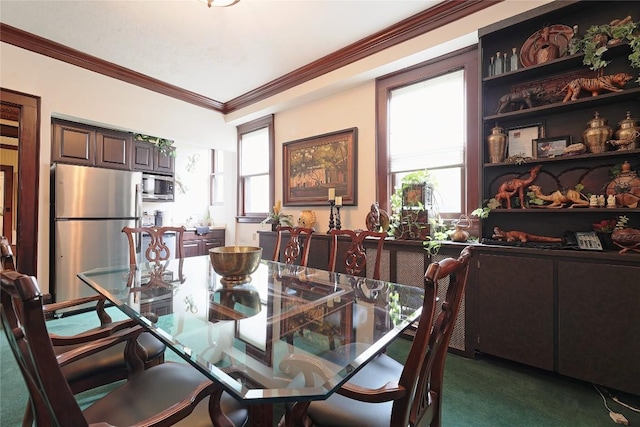 carpeted dining area with a wealth of natural light and ornamental molding