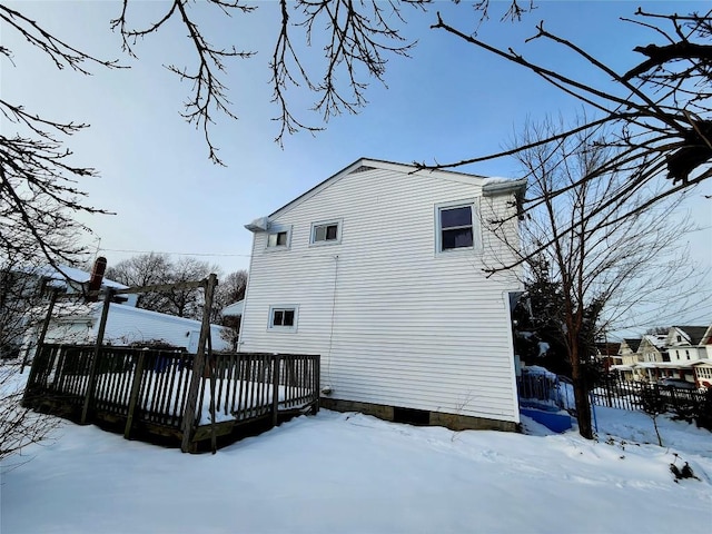 snow covered house with a deck