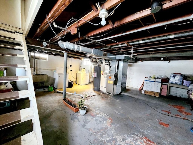 basement featuring washer / dryer, gas water heater, and heating unit