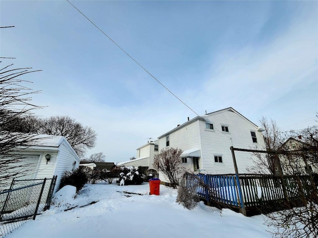 snow covered property with a deck