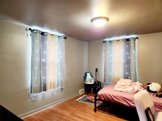 bedroom with wood-type flooring