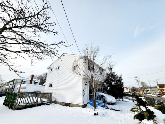 view of snow covered exterior featuring a deck