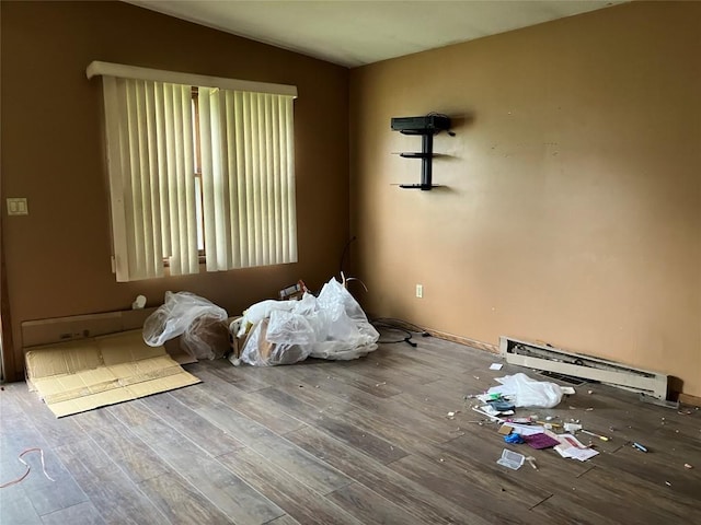 4015 Longview Ave, Erie, PA 16510 - unfurnished bedroom featuring baseboard heating, wood finished floors, and vaulted ceiling