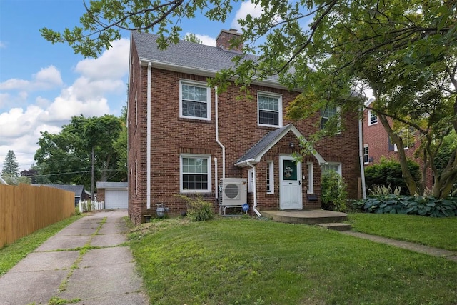 view of front of house featuring a front lawn, ac unit, an outdoor structure, and a garage