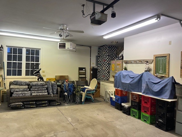 garage with ceiling fan and a garage door opener