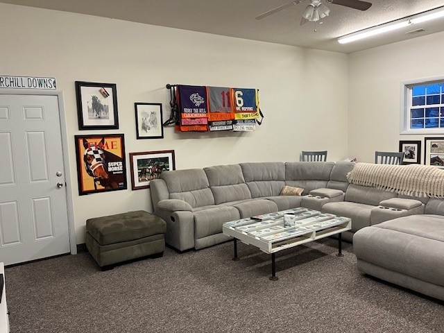 carpeted living room featuring visible vents, a textured ceiling, and ceiling fan