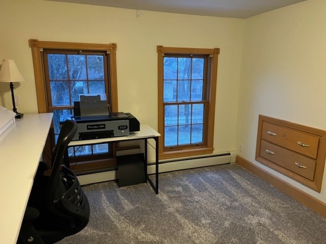 office with a baseboard heating unit and dark carpet