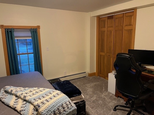 carpeted bedroom featuring a baseboard radiator and a closet