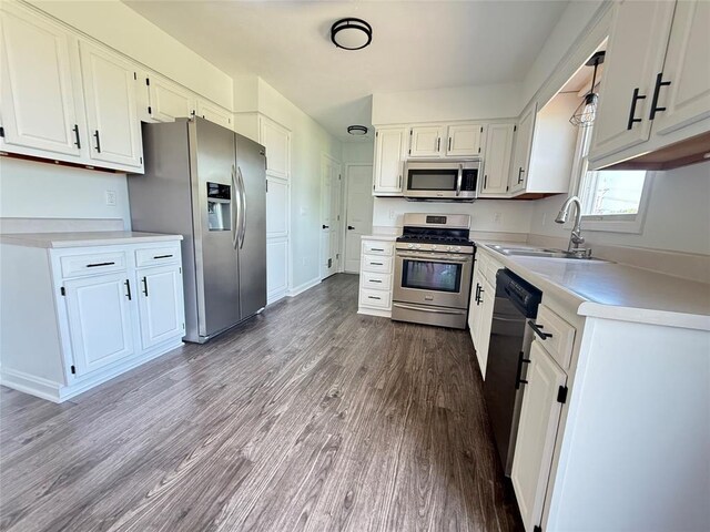 816 E Grandview Blvd, Erie, PA 16504 - kitchen with stainless steel appliances, wood finished floors, white cabinetry, and light countertops