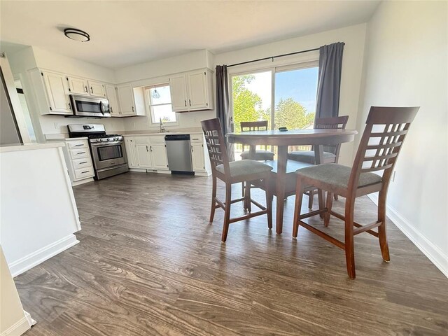 816 E Grandview Blvd, Erie, PA 16504 - kitchen with appliances with stainless steel finishes, dark wood-style flooring, light countertops, and white cabinetry