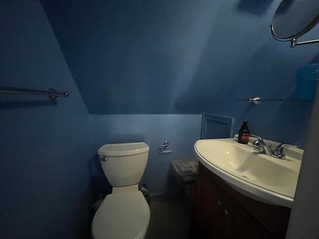 half bathroom featuring toilet and vanity