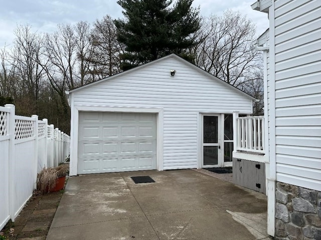 detached garage with driveway and fence