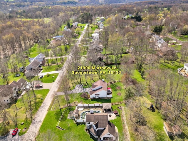 birds eye view of property featuring a view of trees and a residential view