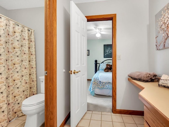 bathroom with toilet, tile patterned floors, a ceiling fan, ensuite bathroom, and a shower with curtain