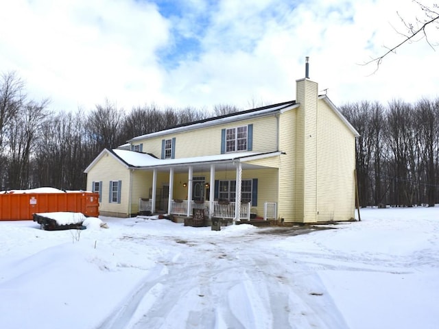 view of front of property featuring covered porch and a chimney