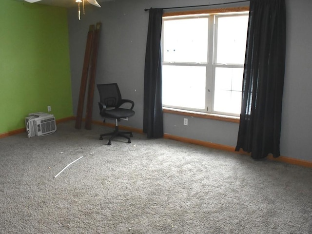 unfurnished room featuring carpet floors, plenty of natural light, and baseboards