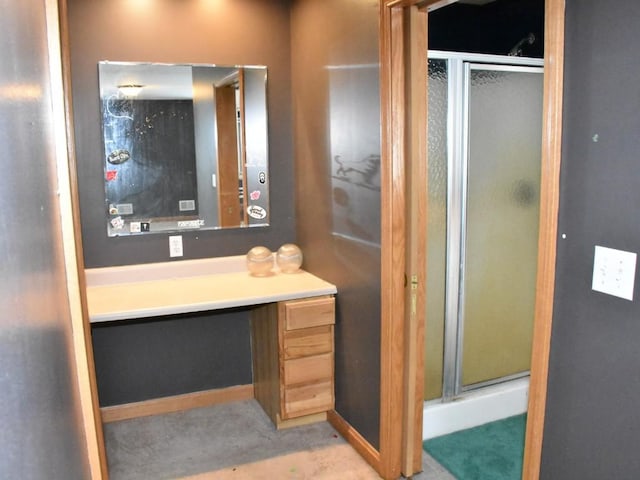 bathroom featuring a shower stall and vanity