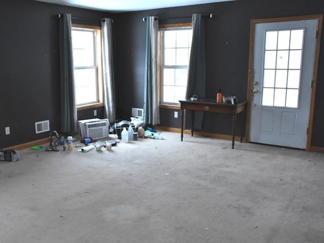 interior space with visible vents, a wealth of natural light, and baseboards