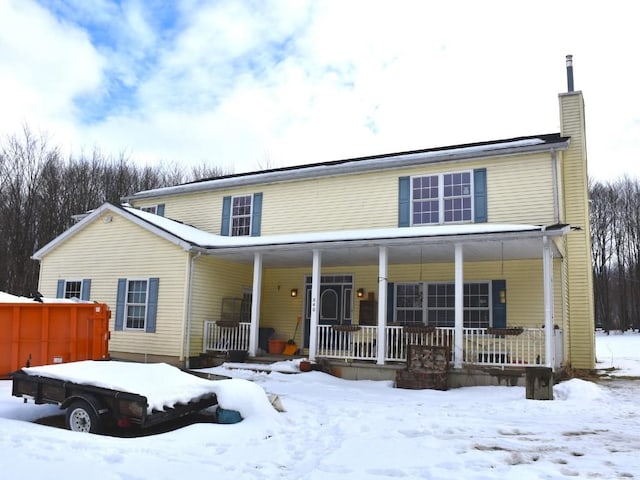 view of front of home featuring a porch and a chimney